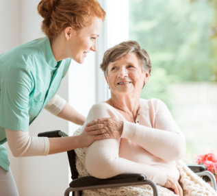 senior woman touching caregivers hand