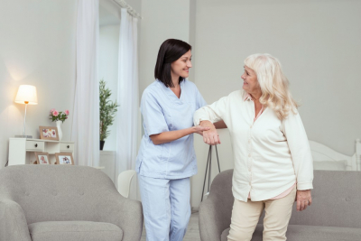 caregiver guiding senior woman