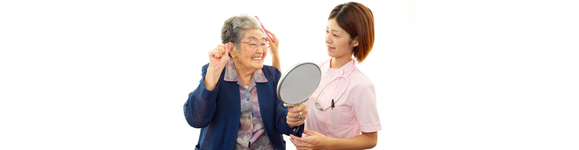 caregiver showing mirror to senior woman